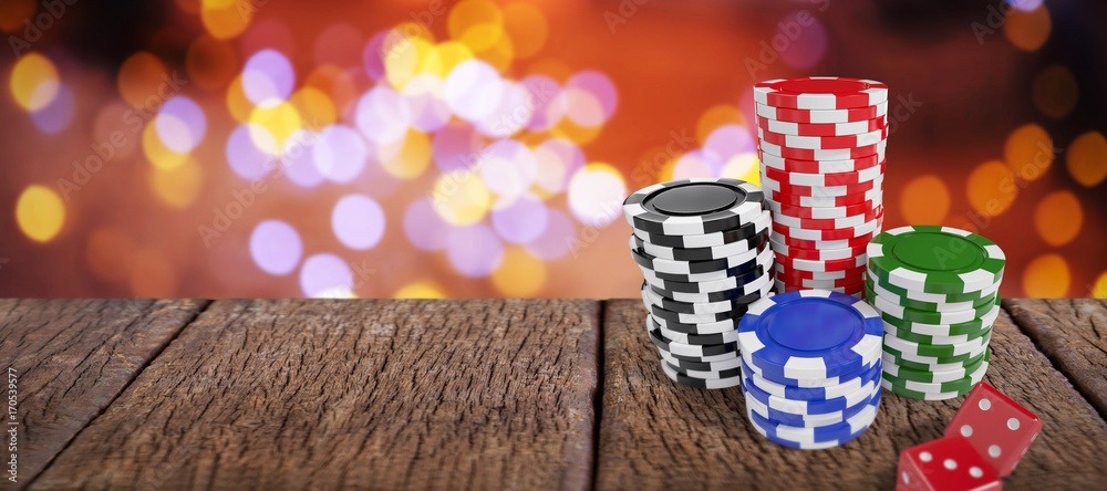 Obraz premium Composite image of stack of colorful casino tokens by red dice