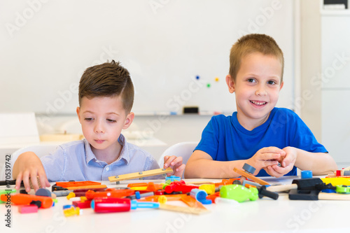 two child boy play repair toys