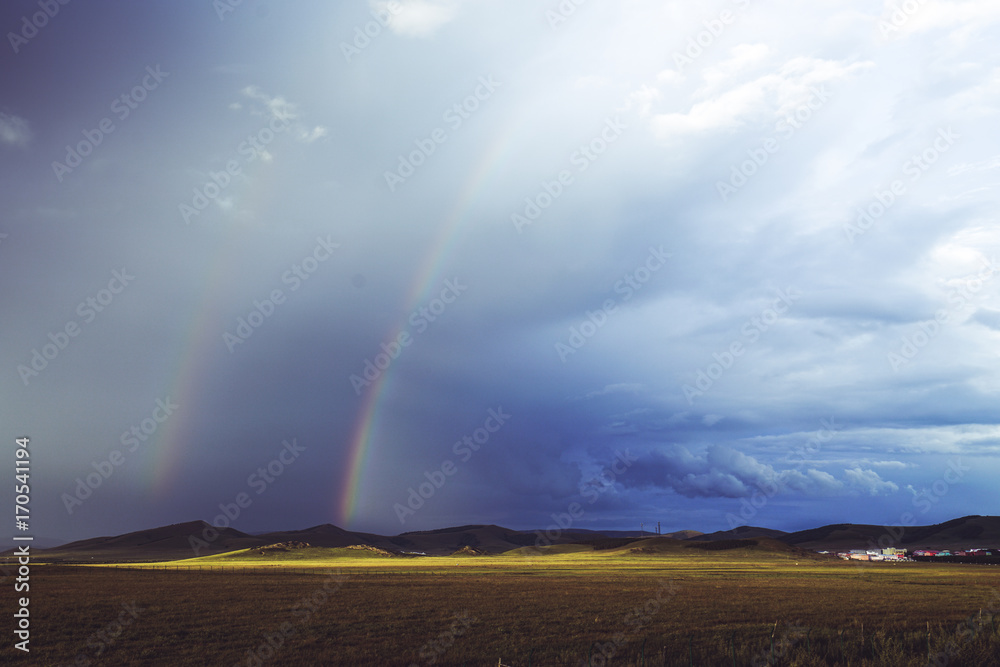 rainbow over grassland
