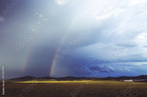 rainbow over grassland