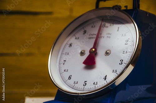 Dial Spring scales over the wooden background