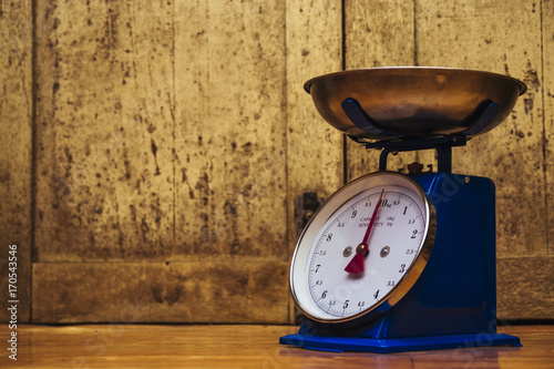 Dial Spring scales over the wooden background