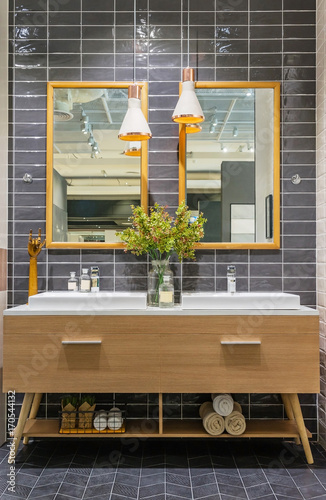 modern bathroom interior in foreground of counter top washbasin in a contemporary style using natural materials.