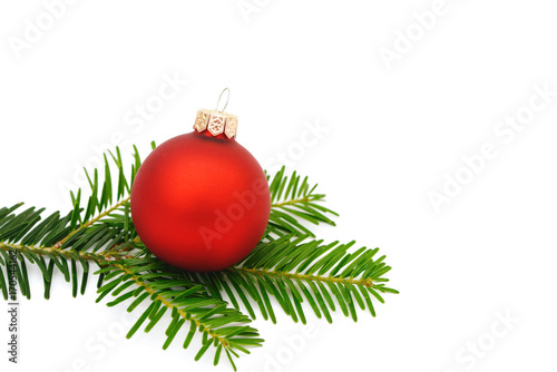 red xmas bauble with fir branch on white