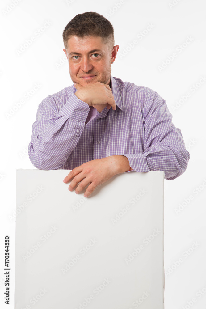Young confident man portrait of a confident businessman showing presentation, pointing paper placard gray background. Ideal for banners, registration forms, presentation, landings, presenting concept. Young confident man portrait of a confident businessman showing presentation, pointing paper placard gray background. Ideal for banners, registration forms, presentation, landings, presenting concept.