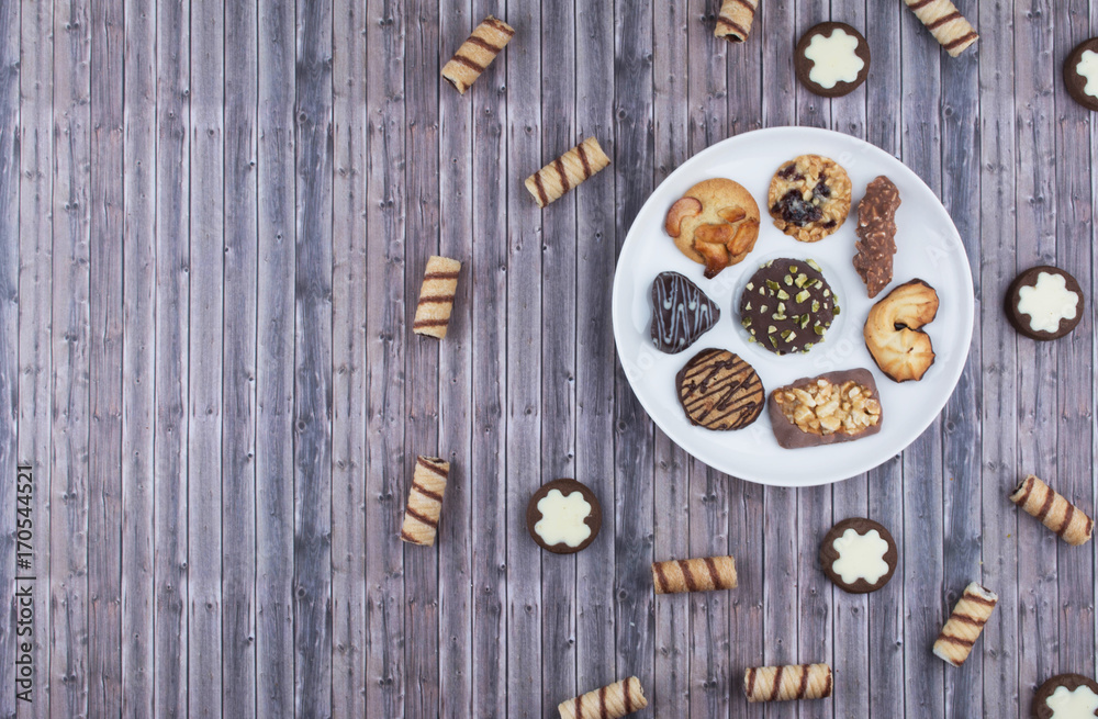 Dark vintage background with various homemade cookies.