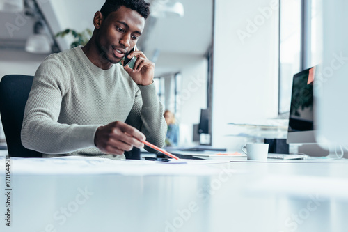 African male architect working in office