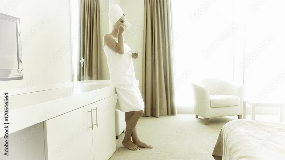 Woman drinking coffee in hotel room sunny morning Woman drinking coffee in hotel room sunny morning