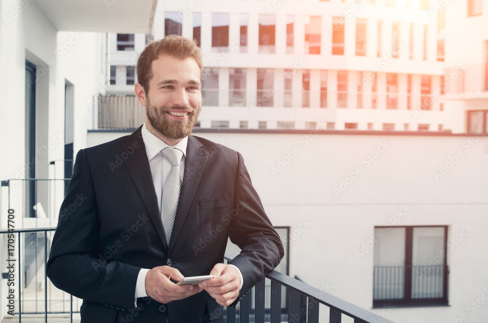 Young entrepreneur uses the phone on the balcony Young entrepreneur uses the phone on the balcony