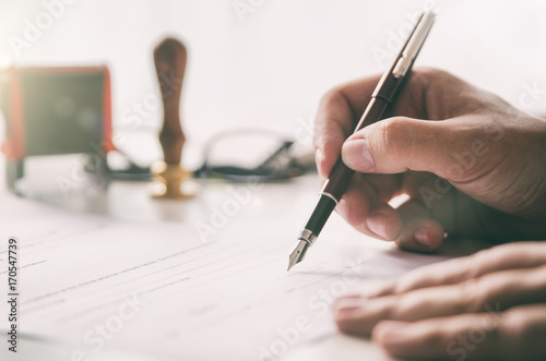 Notary signs legal contract. Businessman working in office