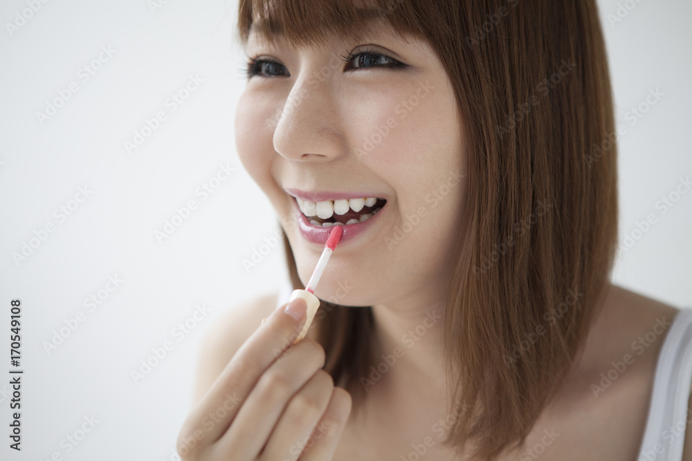The woman is painting lipstick The woman is painting lipstick