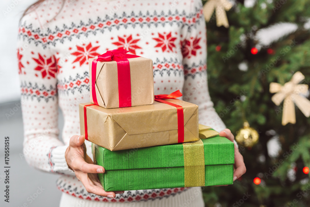 girl holding christmas presents girl holding christmas presents