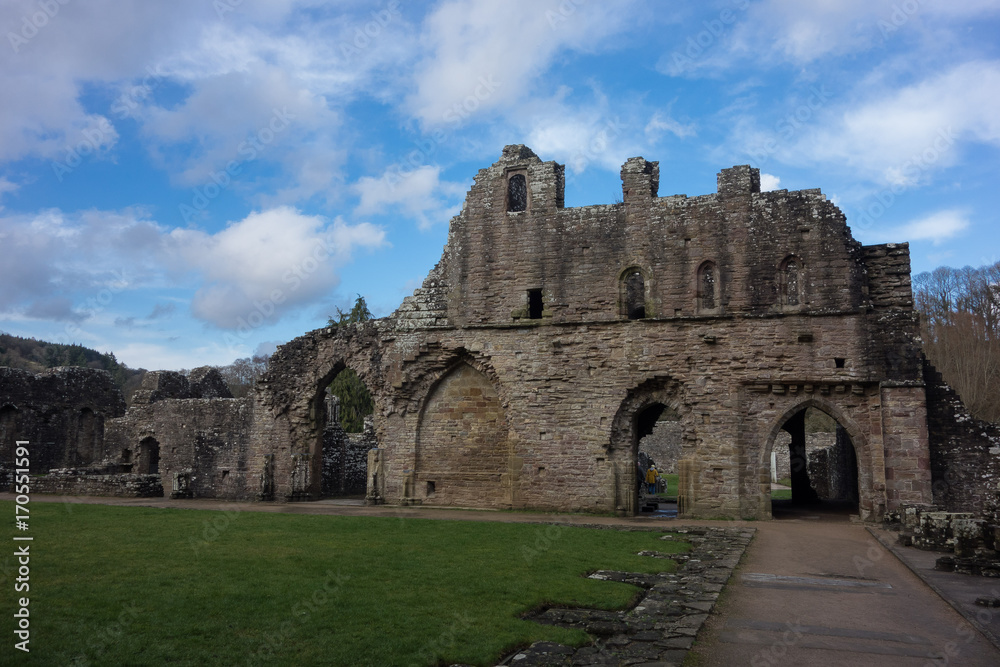 Chepstow castle courtyard against puffy clouds