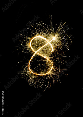 "8" number drawn with bengali sparkles isolated on black backgroundnumber from sparkler on black background