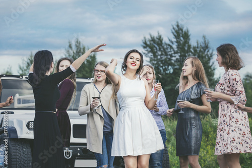 Fotografie Young beautiful happy women celebrate bachelorette party in a convertible limous