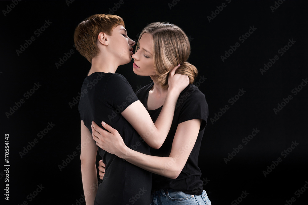 lesbian couple leaning in for kiss lesbian couple leaning in for kiss