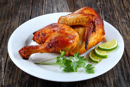 Obraz na plátně half of appetizing grilled chicken on plate