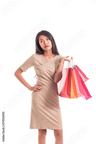 Cheerful shopping woman of Asian holding bags. Shopping smart business woman unhappy Bored and tired holding colorful shopping bags isolated on white . Fresh young Asian female model