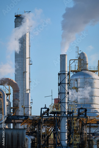 Complesso industriale con ciminiere e fumi photo