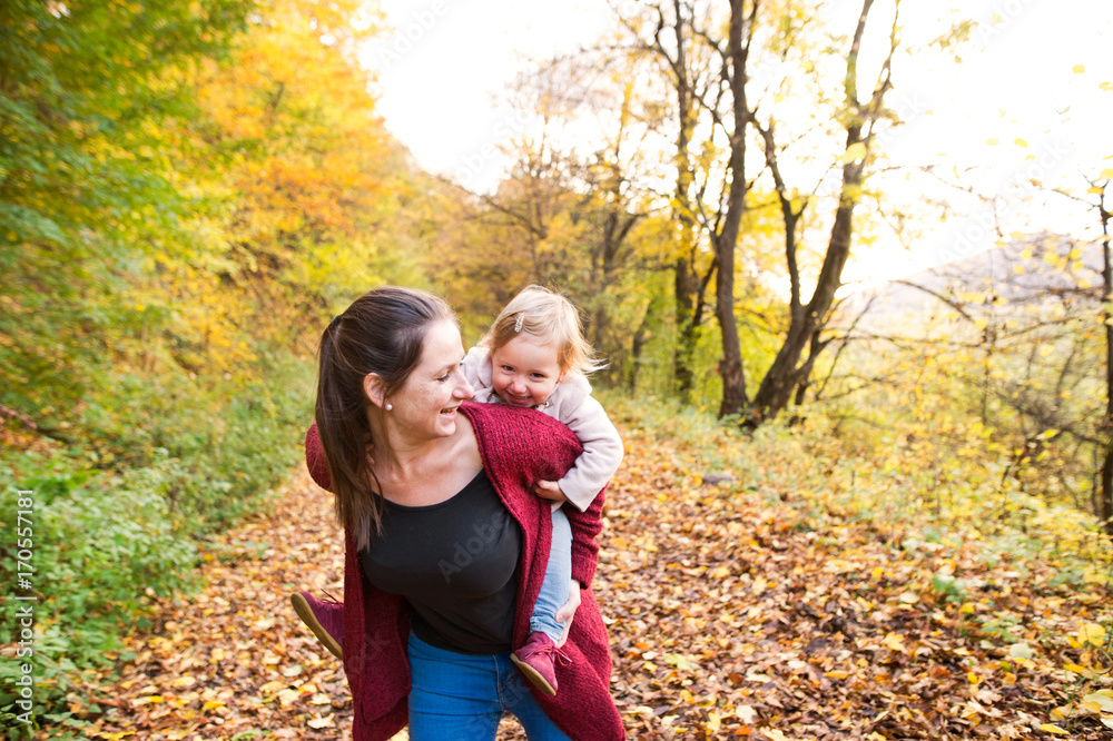 Mother and daughter on a walk in autumn forest. Mother and daughter on a walk in autumn forest.