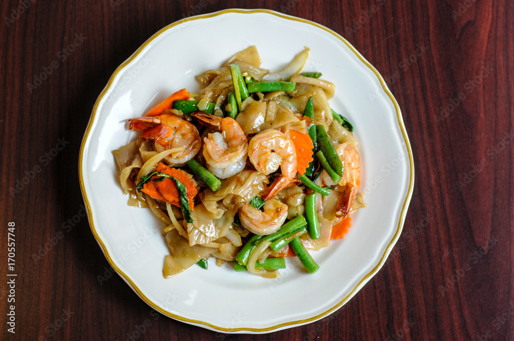 Pad Khee Mao, Stir-fried with wide rice noodles, hot peppers, carrots, green beans, onions, tomato and sweet basil leaves. Pad Khee Mao, Stir-fried with wide rice noodles, hot peppers, carrots, green beans, onions, tomato and sweet basil leaves.