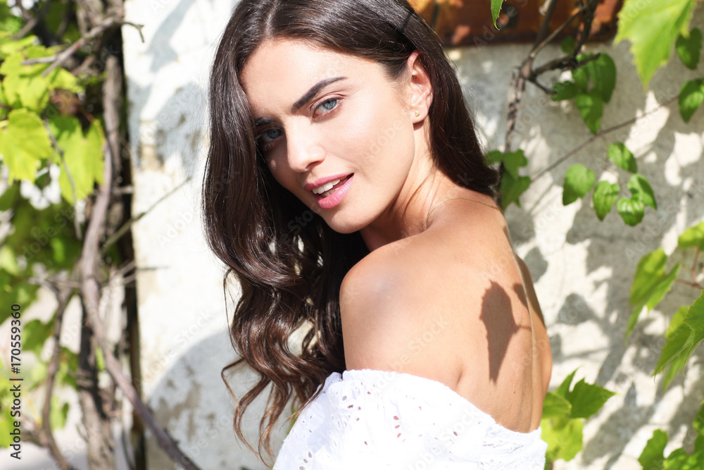 Beautiful brunette posing in the `garden.