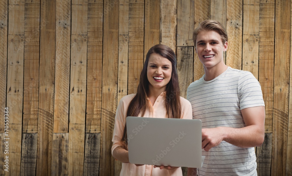 Composite image of young smiling posing with a laptop Composite image of young smiling posing with a laptop