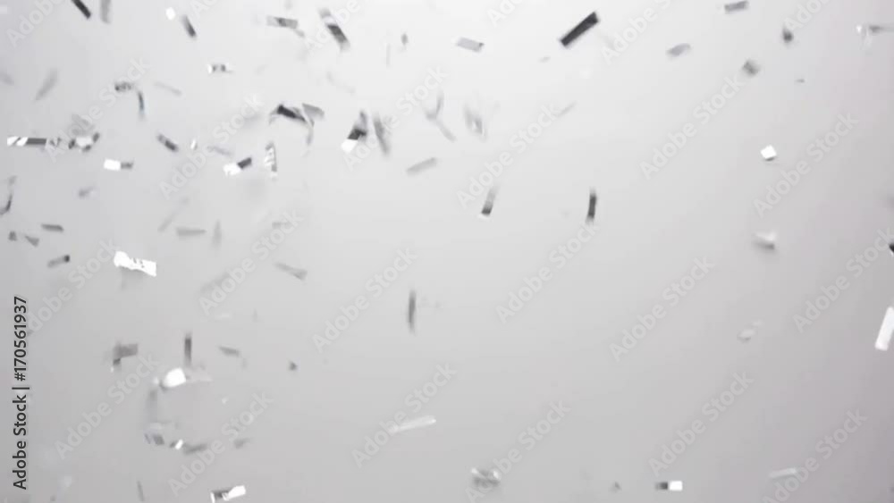 silver confetti falling over white background