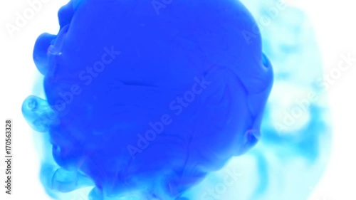 Dropping blue ink paint exploding in water abstract background