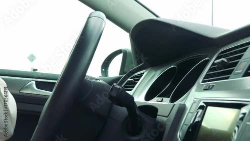 Wallpaper Mural Woman drives a car in the city and waits at a crossroads, then she continues in road - closeup of the steering wheel  Torontodigital.ca