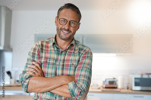 Cheerful mature man with eyeglasses looking at camera