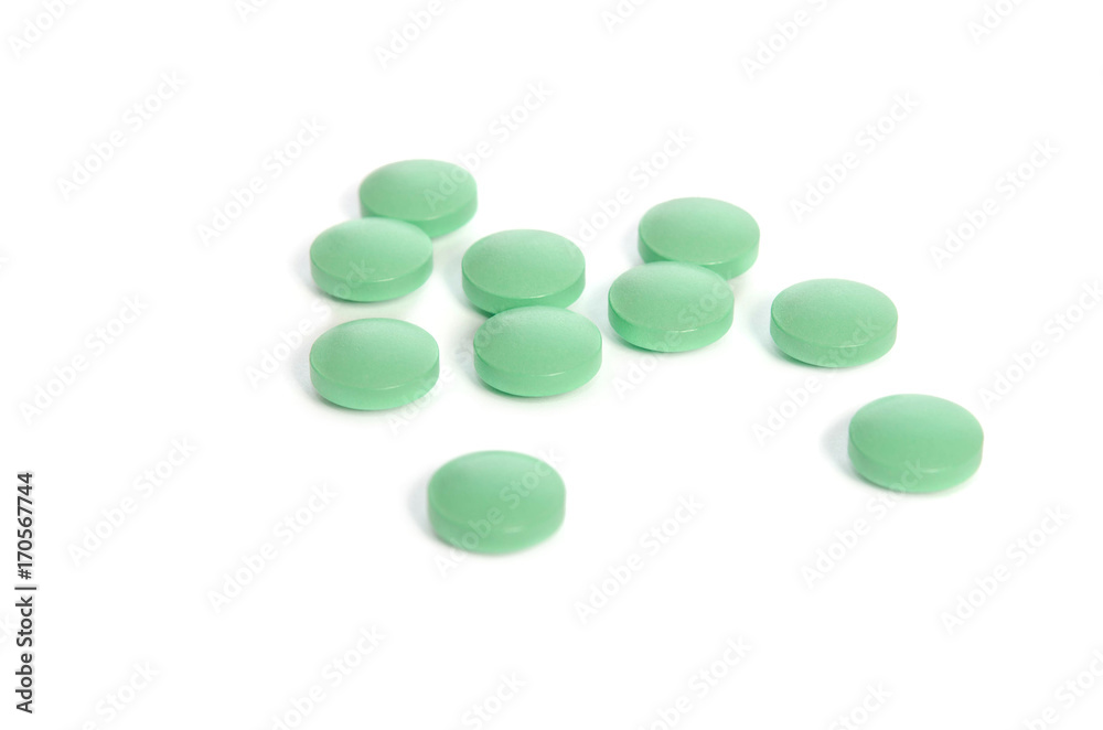 Pile of light green pills isolated on white background Pile of light green pills isolated on white background