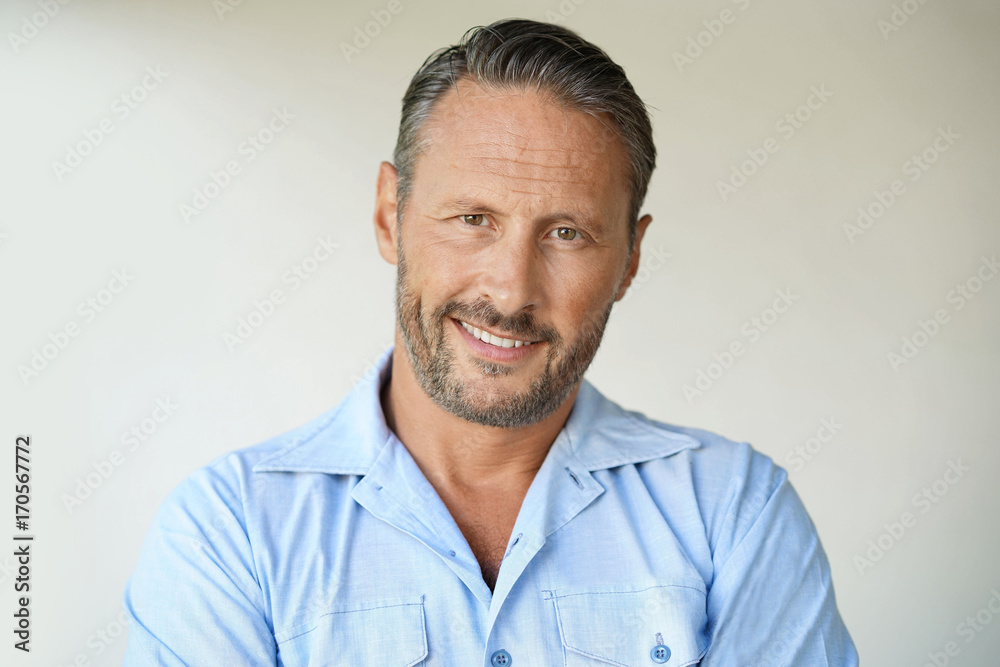 Fototapeta premium Portrait of mature man with blue shirt, isolated