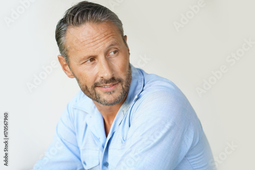 Portrait of mature man with blue shirt, isolated