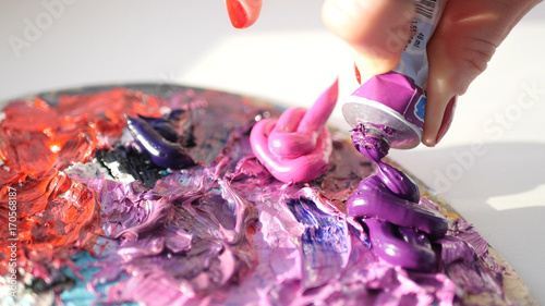 Slika na platnu artist squeezes from the tube to the palette purple oily pink paint , HD