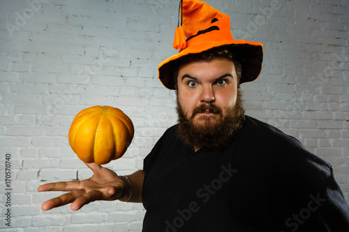 Man playing with pumpkin, halloween photo