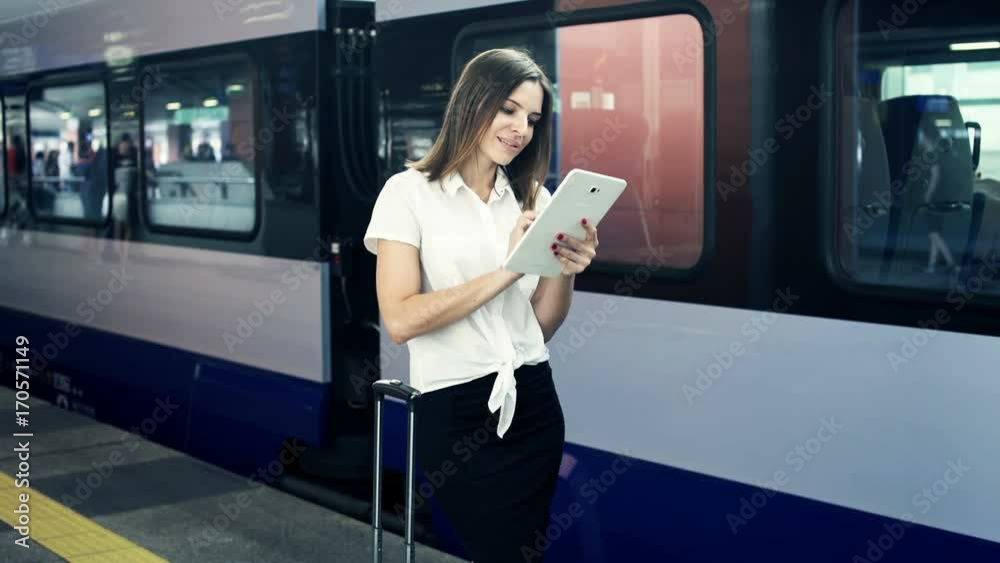 Businesswoman working on tablet computer standing at the railway station
Businesswoman working on tablet computer standing at the railway station