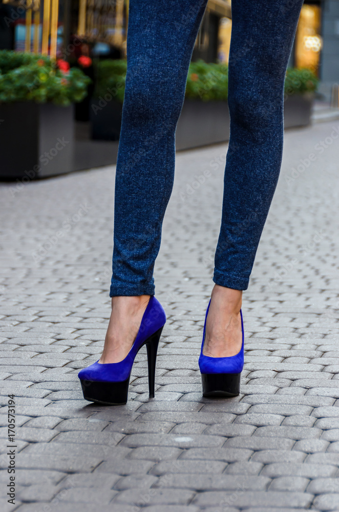 Beautiful slender female legs in tight jeans and blue shoes on a platform and  high heels Stock-Foto | Adobe Stock