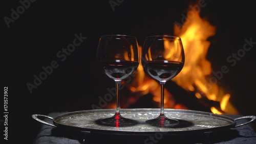 two glasses of wine on the background of fire