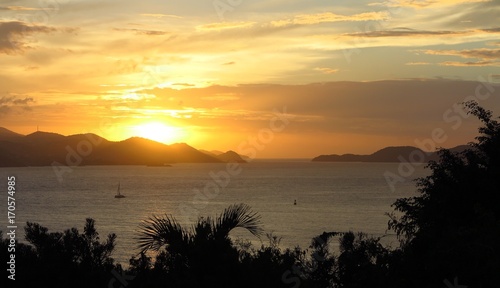 sunrise sunset over distant islands