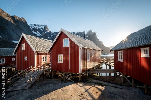 Red Classic Norwegian Rorbu fishing huts with sod roof on Lofoten islands. Norwegian traditional type of house used by fishermen