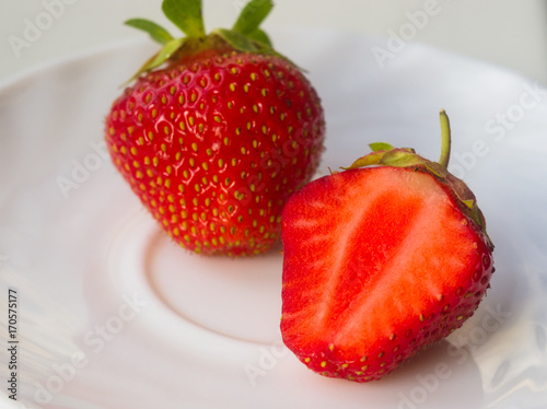 half of the cut fresh ripe strawberries, macro photo