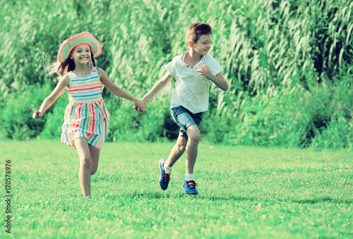 two little children active playing and running outdoors