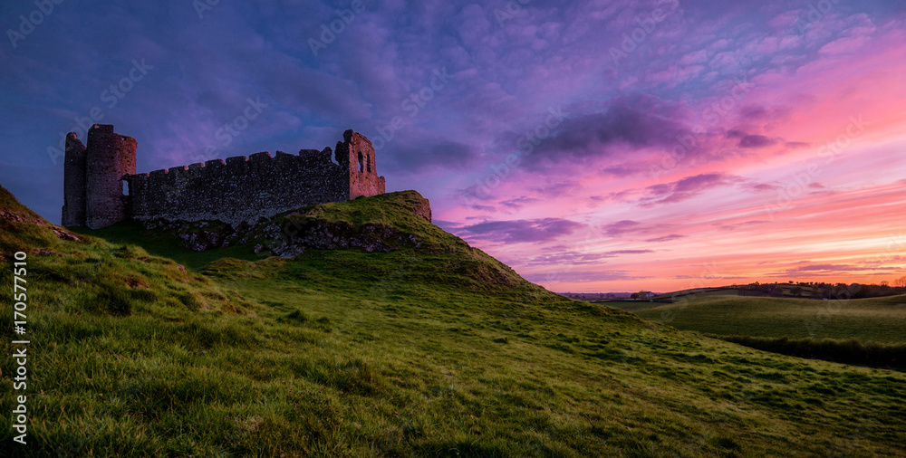 Another sunset: Roche Castle staring at relish and pinkish Sunset in County Louth, Ireland