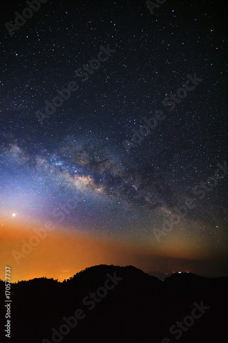 Starry night sky with high moutain and milky way galaxy with stars and space dust in the universe