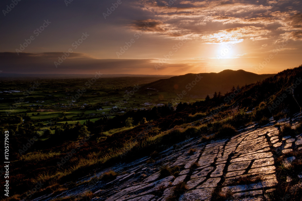 The Camel Mountain: just before the last reflection of light on those eroded stones above the going to sleep quiet Irish plain, Croslieve, Slieve Gullion, County Down, Northern Ireland, United Kingdom