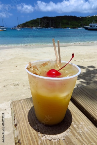 Canvas Print Painkiller rum cocktail on the beach in St