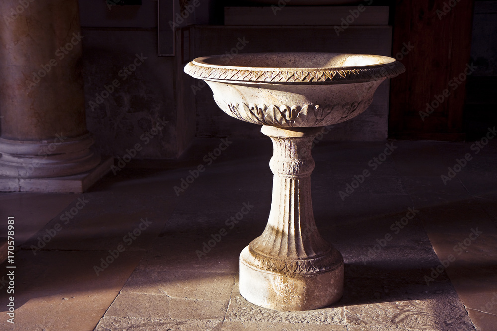 Inlaid marble holy water font in an Italian church (Italy) - image with copy space Inlaid marble holy water font in an Italian church (Italy) - image with copy space
