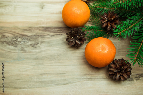 Christmas background with fur-tree branches, cones, dried oranges,Still life of Christmas accessories and stuff. Mittens - top view