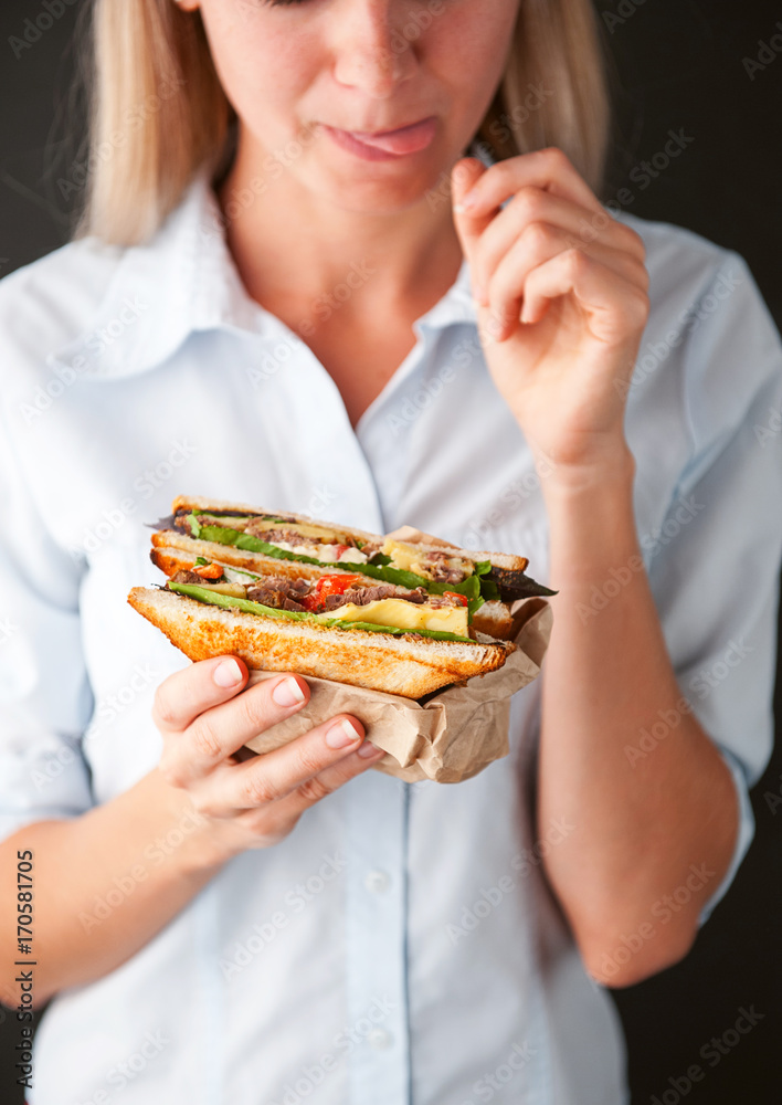 girl licks fingers holding a delicious sandwich girl licks fingers holding a delicious sandwich